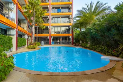 a large swimming pool in front of a building at NaiHarn Sea Condo by Holy Cow, 1-BR, courtyard view in Nai Harn Beach