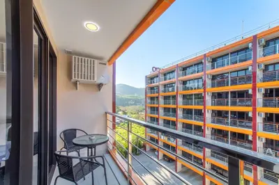 a balcony with a view of a building at SOLA Condo 1BR Tropical View NBC Nai Harn Nai in Rawai Beach