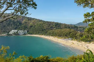 a beach with a bunch of people in the water at Relife Windy by Holy Cow, studio with podium in Nai Harn Beach