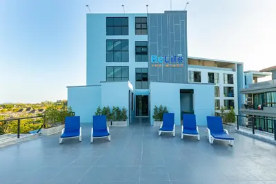 a group of blue chairs sitting on a building at Relife Windy by Holy Cow, country view in Rawai Beach