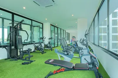 a gym with a row of treadmills and exercise bikes at Relife Windy by Holy Cow, country view in Rawai Beach