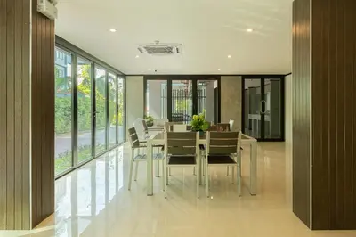 a dining room with a table and chairs and windows at Relife Windy by Holy Cow, country view in Rawai Beach
