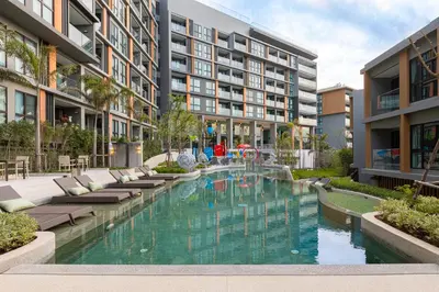 a swimming pool in the middle of a building at Sea View Panora Surin by Holy Cow, 1-BR in Surin Beach
