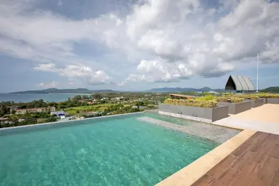 a swimming pool on the roof of a house with a view at Sea View Panora Surin by Holy Cow, 1-BR in Surin Beach