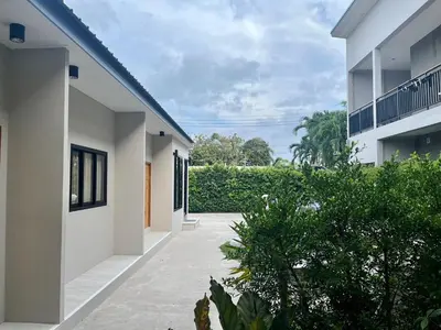 an empty courtyard of a house with plants at The Grey House Palai Phuket in Chalong