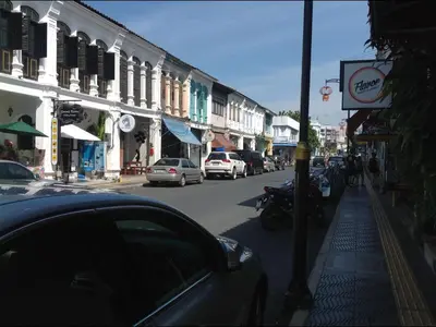 a street with cars parked on the side of the road at Phuket Town Budget House - Aircon Room #1 in Ban Lo Long