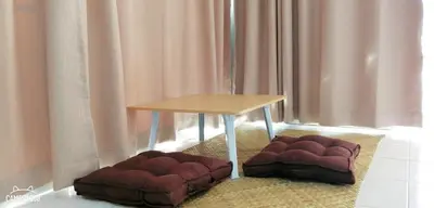 a table and two dog beds in a room at Khao Thong Home Stay in Krabi town
