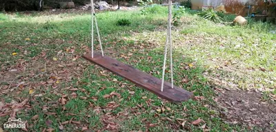 a swing sitting in the grass in a yard at Khao Thong Home Stay in Krabi town