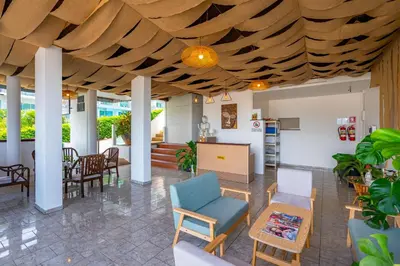 a living room with a wooden ceiling at Kata Hill Sea View Hotel in Kata Beach