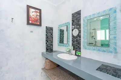 a bathroom with a sink and a mirror at Kata Hill Sea View Hotel in Kata Beach