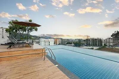 a swimming pool on the roof of a building at Dome Kata Resort in Kata Beach