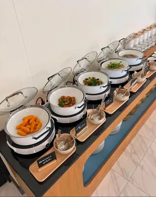 a buffet with many pots and pans on a table at Dome Kata Resort in Kata Beach