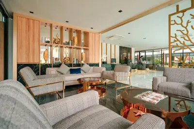 a living room with couches and a table at Wekata Luxury in Kata Beach