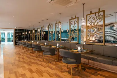 a restaurant with a row of tables and chairs at Wekata Luxury in Kata Beach
