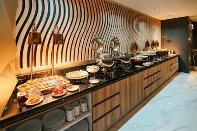 a buffet line with glasses of wine and food at Wekata Luxury in Kata Beach