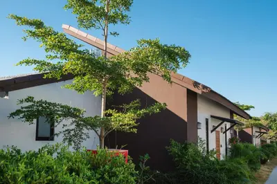a house with a tree in front of it at Thames Tara Private Pool Villa Rawai Phuket in Rawai Beach