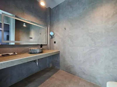 a bathroom with a sink and a mirror at Little Loft Hotel in Phuket Town