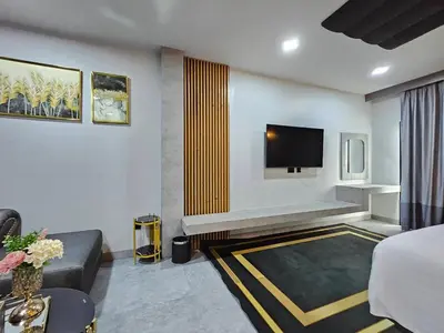 a hotel room with a bed and a tv at Little Loft Hotel in Phuket Town