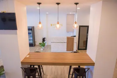 a dining room with a wooden table and chairs at Mystays Phuket in Phuket Town