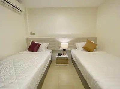 two beds sitting next to each other in a room at Mystays Phuket in Phuket Town