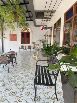 a patio with chairs and tables in a building at Mystays Phuket in Phuket Town