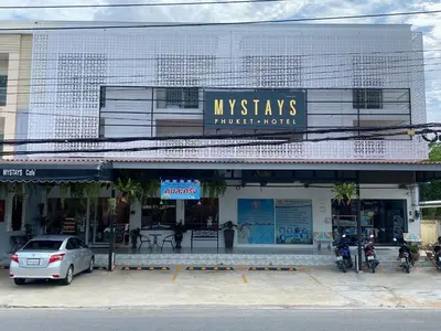 a white car parked in front of a building at Mystays Phuket in Phuket Town