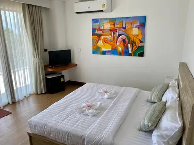 a bedroom with a bed with two dishes on it at Villa Tango Victoria Resort, Koh Yao Noi in Ko Yao Noi