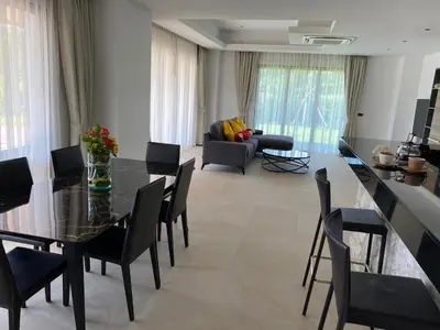 a living room with a black table and chairs at Villa Tango Victoria Resort, Koh Yao Noi in Ko Yao Noi