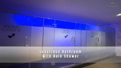 a room with a glass wall with the wordsciplinary bathroom with rain shower at PERA SPACE Capsule Hotel in Phuket Town