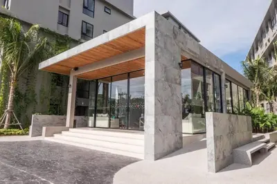 a building with glass doors and stairs next to a building at Diamond CONDO by VС in Bang Tao Beach