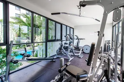 a gym with treadmills and elliptical machines at Diamond CONDO by VС in Bang Tao Beach