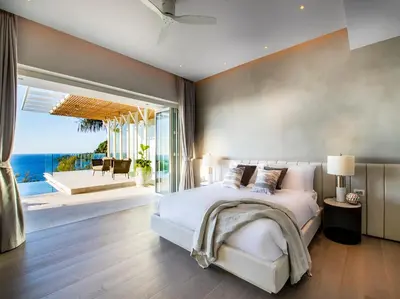 a bedroom with a bed with a view of the ocean at Villa Borimas by Elite Havens in Surin Beach