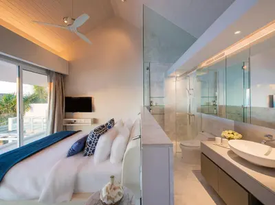 a bedroom with a king sized bed and a sink at Villa Borimas by Elite Havens in Surin Beach