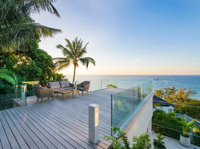 a wooden deck with a view of the ocean at Villa Borimas by Elite Havens in Surin Beach