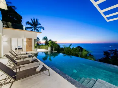 a villa with a swimming pool with a view of the ocean at Villa Borimas by Elite Havens in Surin Beach