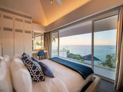 a bedroom with a large bed and a large window at Villa Borimas by Elite Havens in Surin Beach