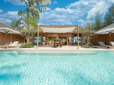 a house with a swimming pool in front of a house at Luxury Beachfront Villa Phuket Private Pool Full Staff At Natai Beach in Natai Beach