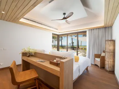 a bedroom with a desk and a bed in a room at Luxury Beachfront Villa Phuket Private Pool Full Staff At Natai Beach in Natai Beach