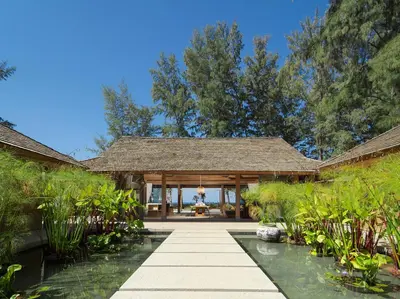 an external view of a house with a pond at Luxury Beachfront Villa Phuket Private Pool Full Staff At Natai Beach in Natai Beach