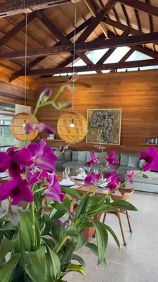 a room with a table and purple flowers in it at Luxury Beachfront Villa Phuket Private Pool Full Staff At Natai Beach in Natai Beach
