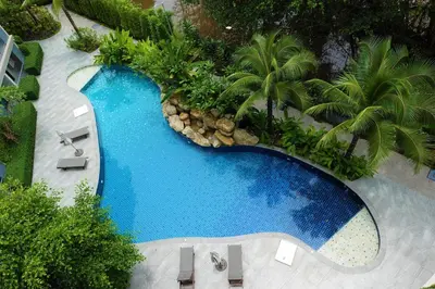 an overhead view of a swimming pool with palm trees at The Title Residencies Naiyang Beach in Nai Yang Beach