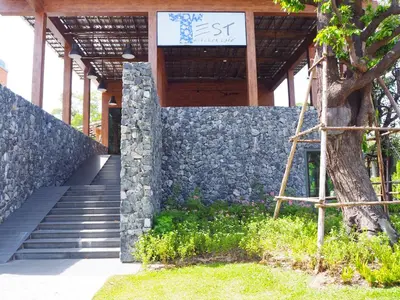 a sign on the side of a building with stairs at The Title Residencies Naiyang Beach in Nai Yang Beach