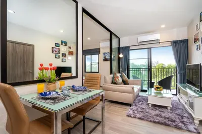 a living room with a table and a couch at The Title Residencies Naiyang Beach in Nai Yang Beach