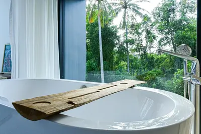 a bathroom with a tub with a wooden board on it at Chomdao Maikhao in Mai Khao Beach