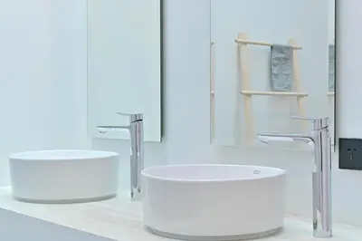a white bathroom with two sinks and a mirror at Chomdao Maikhao in Mai Khao Beach