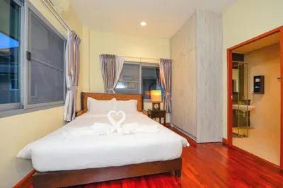 a bedroom with a bed with a white bow on it at 74 Patong villa walk to Bangla Rd in 10min 3 room cozy modern style in Patong Beach