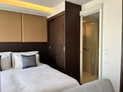 a bedroom with a bed and a walk in shower at Aristo Resort Surin Beach S03 in Surin Beach