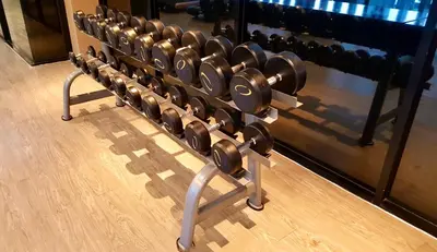 a row of dumbbells on a rack in a gym at Aristo Resort Surin Beach S03 in Surin Beach