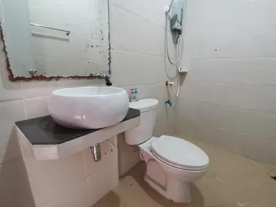 a bathroom with a toilet and a sink and a phone at Nestvilla Khok-kloi Phang-nga in Ban Nai