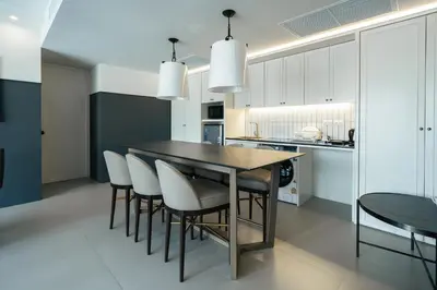 a kitchen with a dining room table and chairs at Marina House MUAYTHAI Ta-iad Phuket in Chalong